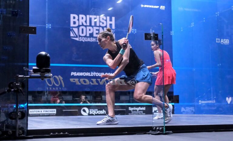 British open squash tournament with two woman playing against each other with photographers in the back